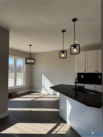 a kitchen with a sink and a stove top oven