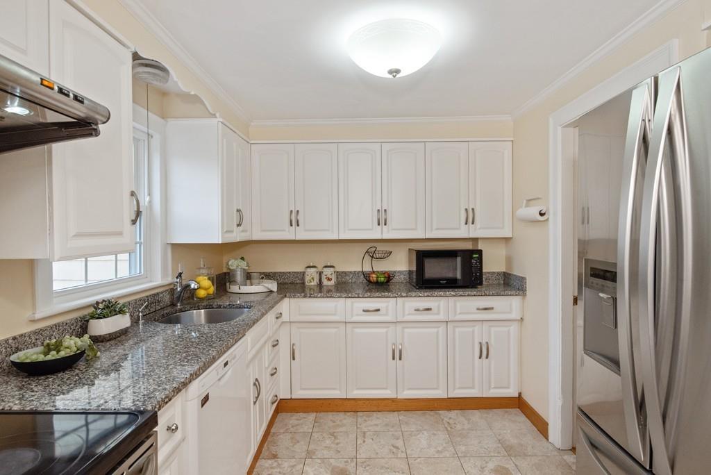 104 Bertwell Road Lexington, MA 02420 - Photo 11 of 32 a kitchen with stainless steel appliances granite countertop a sink stove and refrigerator