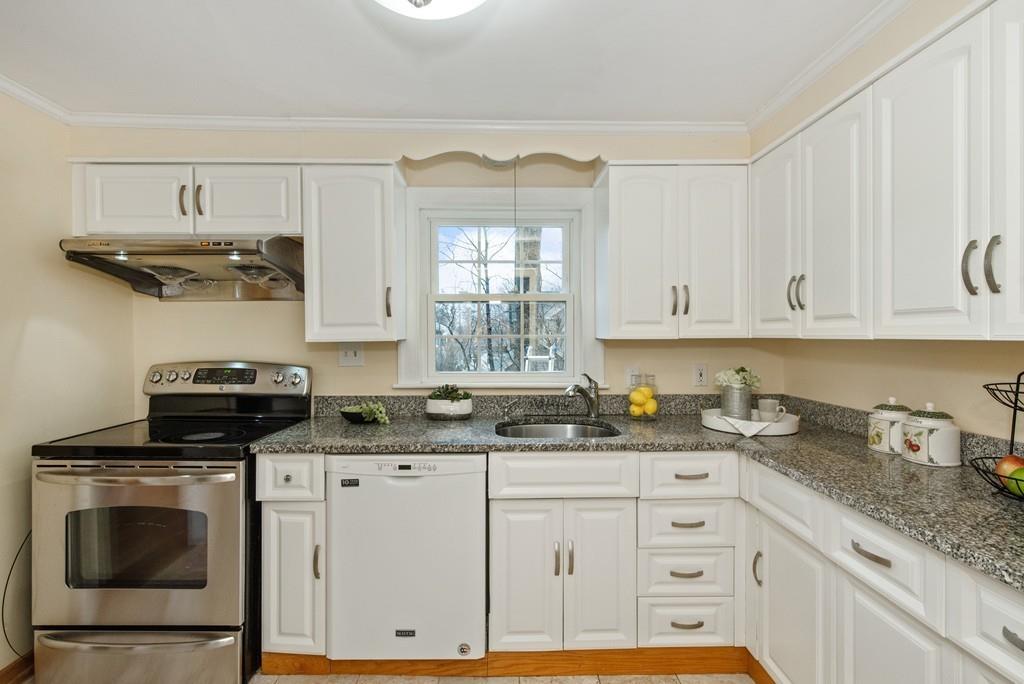 104 Bertwell Road Lexington, MA 02420 - Photo 12 of 32 a kitchen with stainless steel appliances granite countertop a sink a stove a microwave and cabinets
