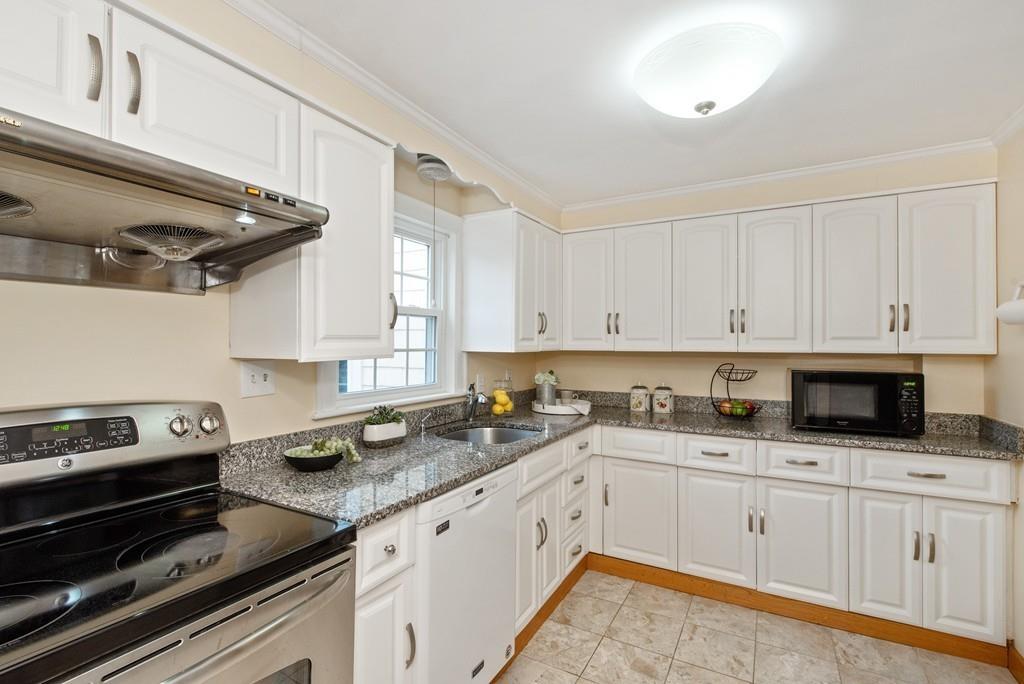 104 Bertwell Road Lexington, MA 02420 - Photo 13 of 32 a kitchen with granite countertop a sink a stove and cabinets