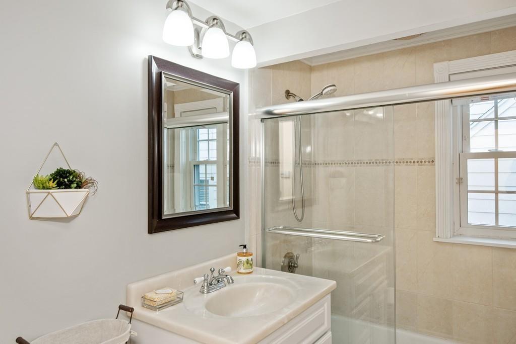 104 Bertwell Road Lexington, MA 02420 - Photo 18 of 32 a bathroom with a sink a mirror and a window
