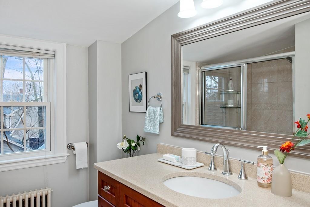 104 Bertwell Road Lexington, MA 02420 - Photo 25 of 32 a bathroom with a granite countertop sink and a mirror
