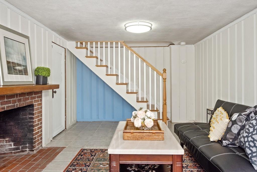 104 Bertwell Road Lexington, MA 02420 - Photo 28 of 32 a living room with furniture and a fireplace