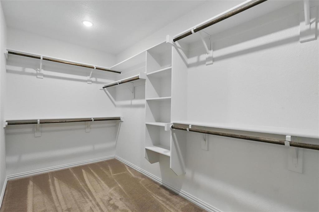 240 Springwood Ranch Loop Springtown, TX 76082 - Photo 16 of 27 a view of walk in closet with empty racks