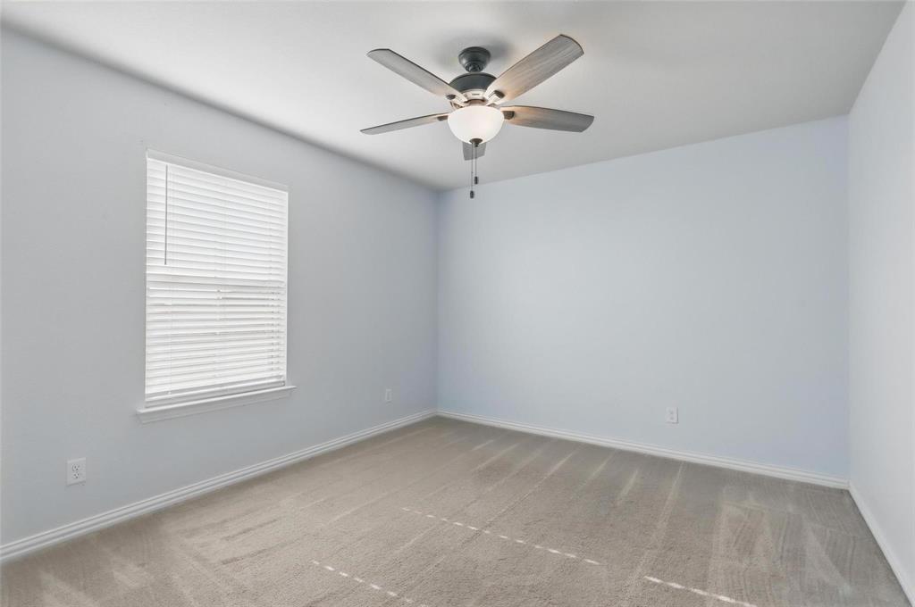 240 Springwood Ranch Loop Springtown, TX 76082 - Photo 17 of 27 an empty room with a window and a fan