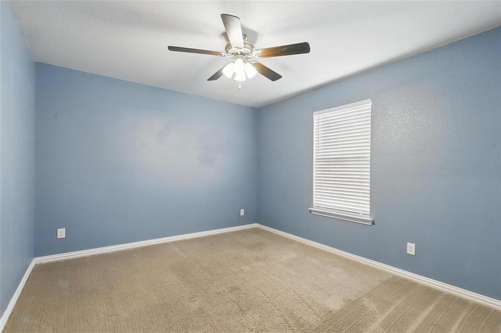 240 Springwood Ranch Loop Springtown, TX 76082 - Photo 19 of 27 an empty room with windows and fan