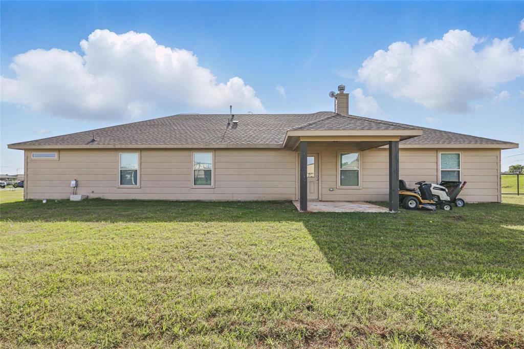 240 Springwood Ranch Loop Springtown, TX 76082 - Photo 22 of 27 a front view of a house with garden