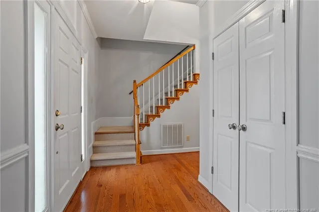 a view of entryway with wooden floor and stairs
