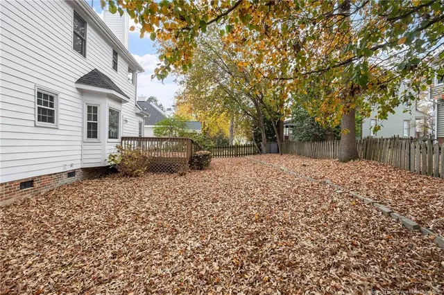 a backyard of a house with a tree