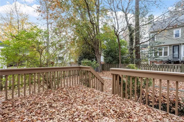 a balcony with wooden floor and fence