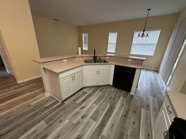 a view of a kitchen with sink and dishwasher
