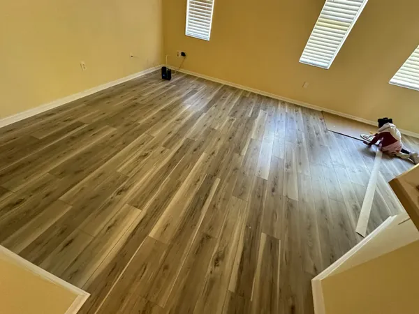 a view of a room with wooden floor and stairs