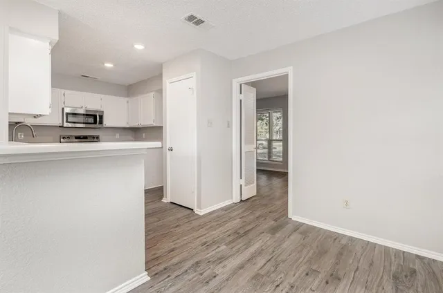 a kitchen with stainless steel appliances a refrigerator and a stove top oven