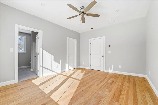 a bedroom with a bed and a ceiling fan
