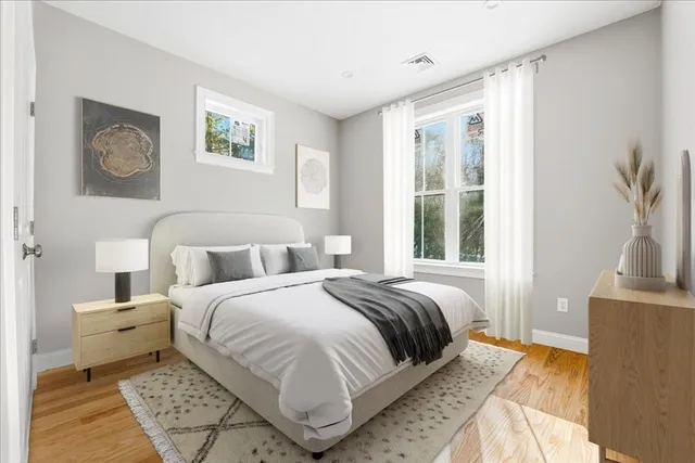 a bedroom with a large bed and a window