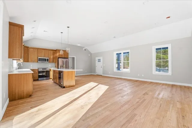 a view of a kitchen with furniture and wooden floor