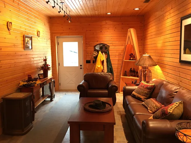 a living room with furniture and a floor to ceiling window