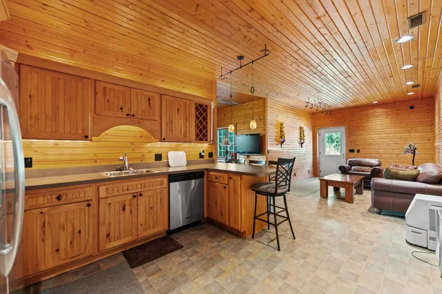 a kitchen with stainless steel appliances granite countertop a sink and cabinets
