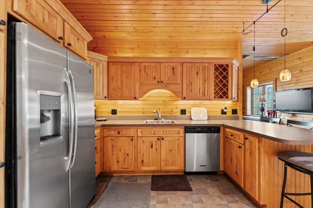 a dining area with furniture and a kitchen view