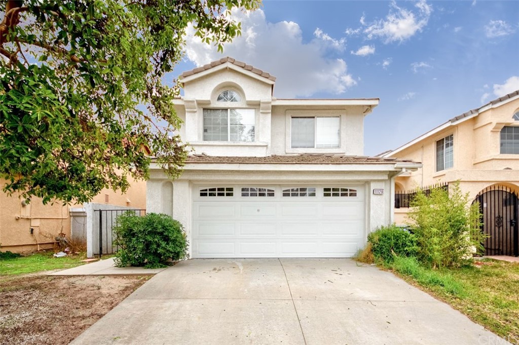 11129 Pacific Street Rancho Cucamonga, CA 91701 - Photo 1 of 1 a view of a white house with a yard and plants