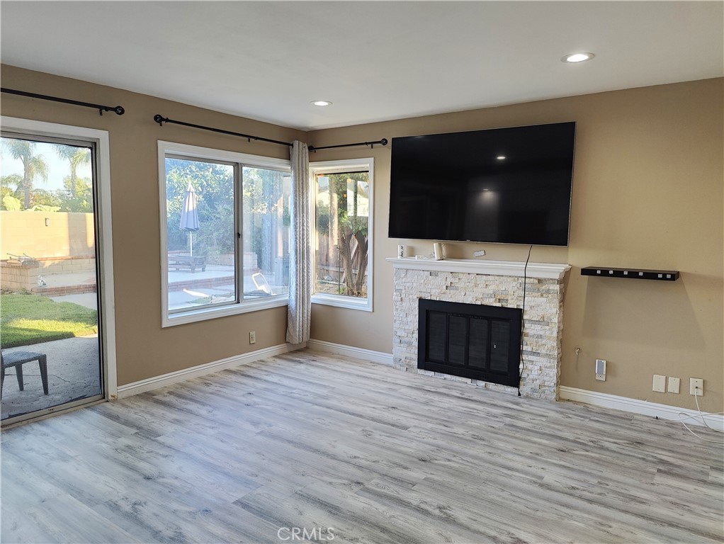 6953 Saddleback Place Rancho Cucamonga, CA 91701 - Photo 10 of 62 Family room with fireplace and patio door to backyard