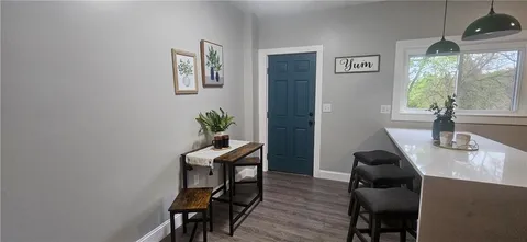 a view of a workspace with furniture and a potted plant