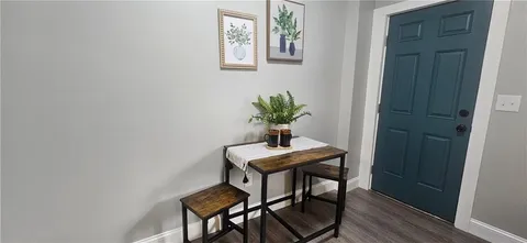 a view of a room with table and hallway