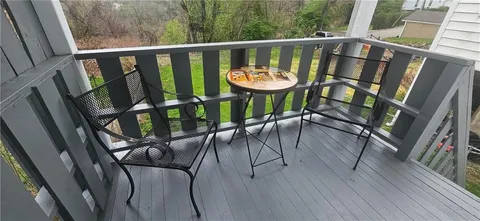 a view of a balcony with furniture