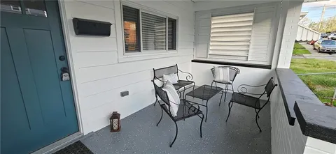 a patio with table and chairs