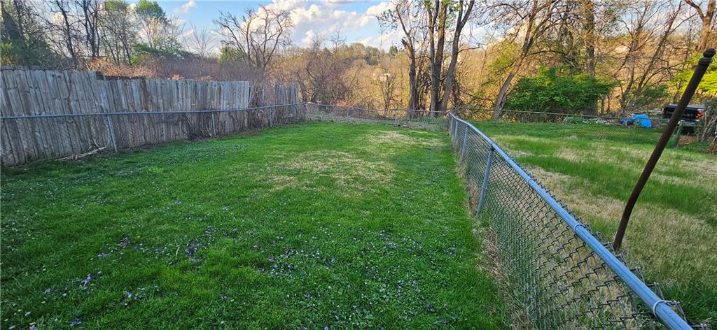 2311 Clinton Street Homestead, PA 15120 - Photo 35 of 38 a view of a yard with large trees and wooden fence