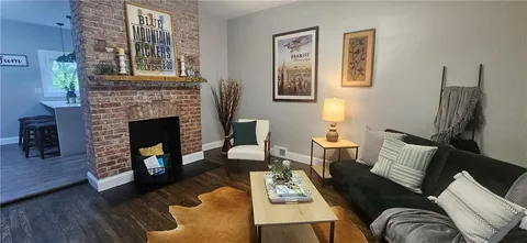 a living room with furniture and a fireplace