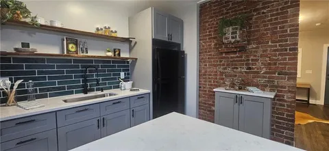a kitchen with a refrigerator and a sink