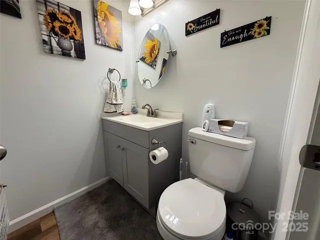 a white toilet sitting next to a bathroom sink