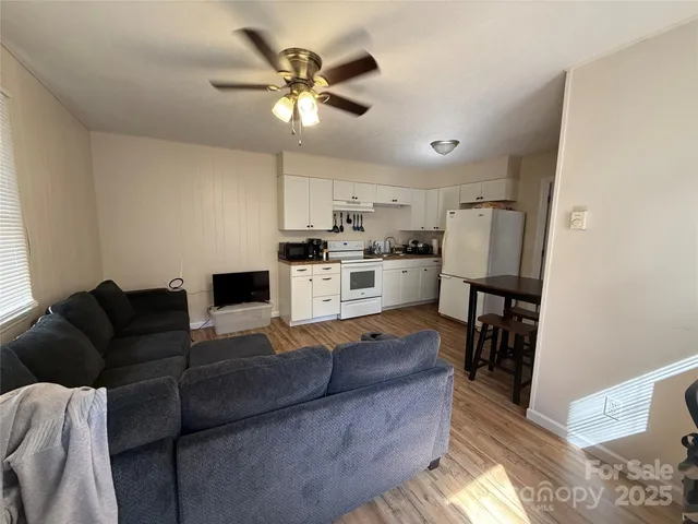 a living room with furniture and a wooden floor