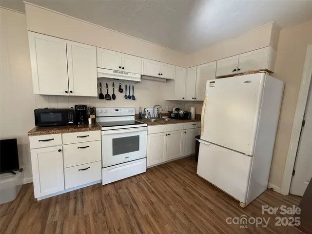 a white refrigerator freezer sitting inside of a kitchen