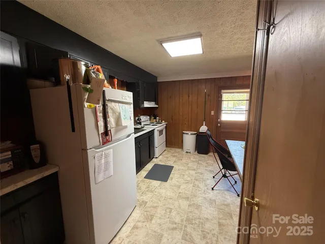 a kitchen with refrigerator and window