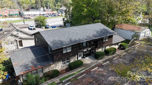 an aerial view of a house with a yard