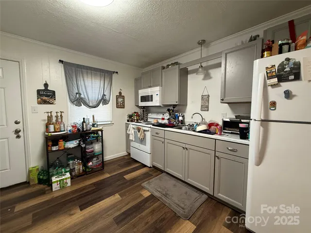 a kitchen with a sink appliances and cabinets