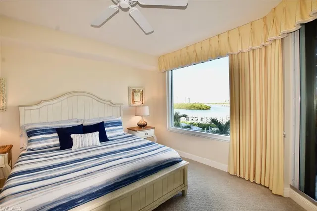 a bedroom with furniture and a large window