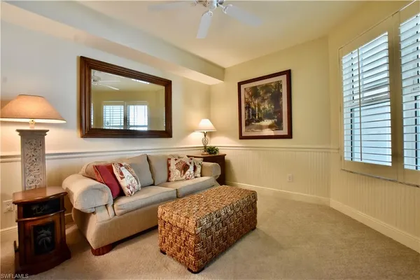 a living room with furniture and a painting