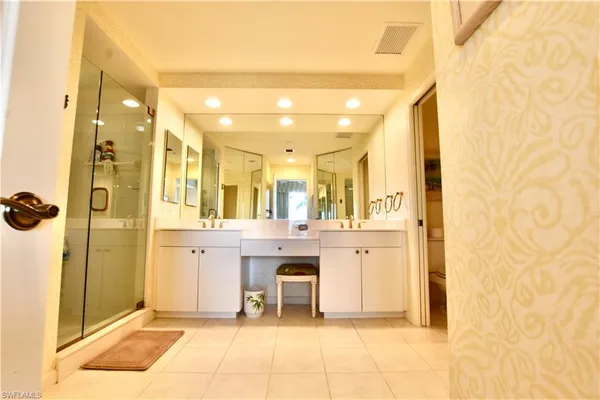a large bathroom with a glass shower door