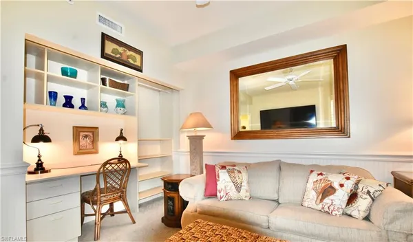 a living room with furniture and a painting