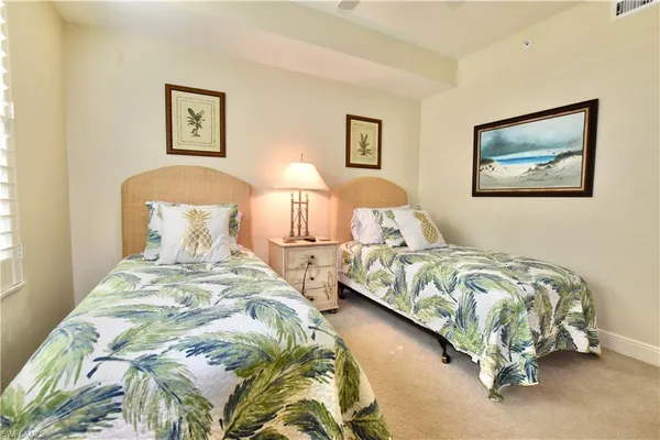 a bedroom with bed and painting on the wall