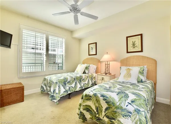 a spacious bedroom with two beds and a couch