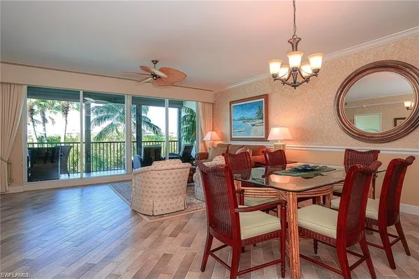 a view of a dining room with furniture wooden floor and chandelier