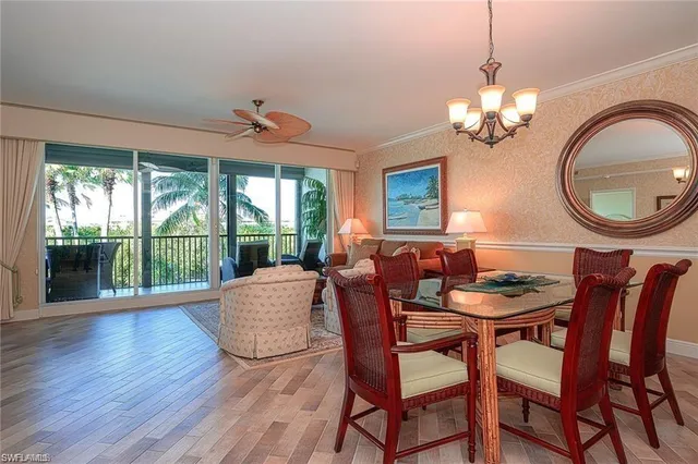a view of a dining room with furniture wooden floor and chandelier