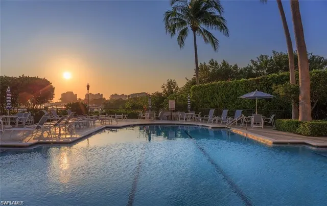 a view of a swimming pool with a table and chairs