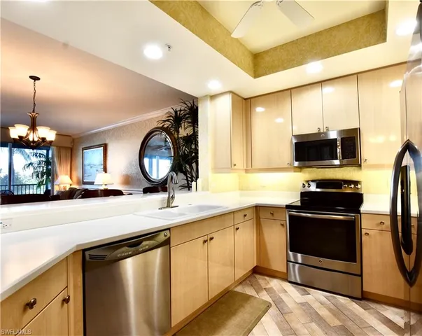 a kitchen with a sink appliances and cabinets