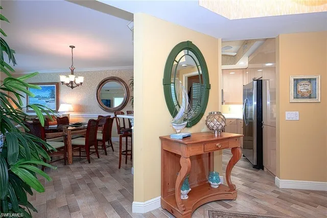 a view of a dining room with furniture and chandelier