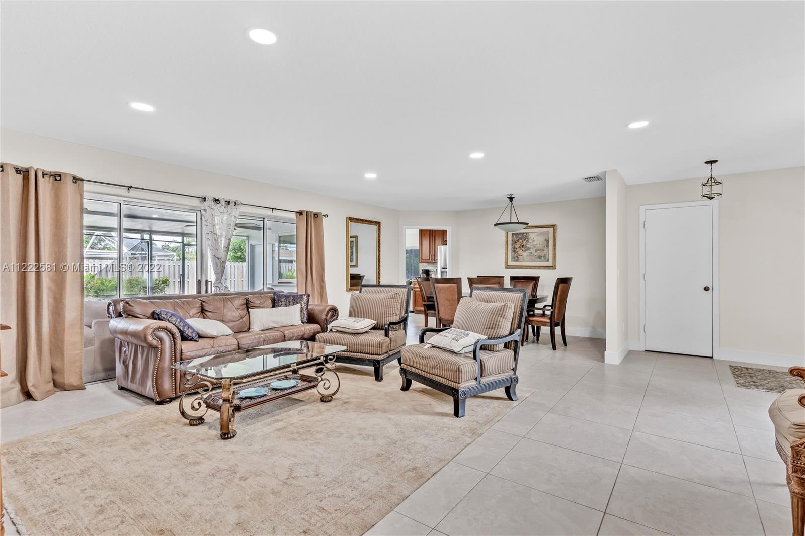 10820 Eureka Street Boca Raton, FL 33428 - Photo 23 of 39 a living room with furniture and a large window